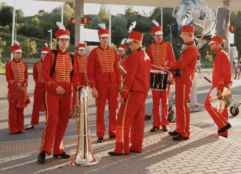 Red marching band costumes designed for bass orchestral performances.