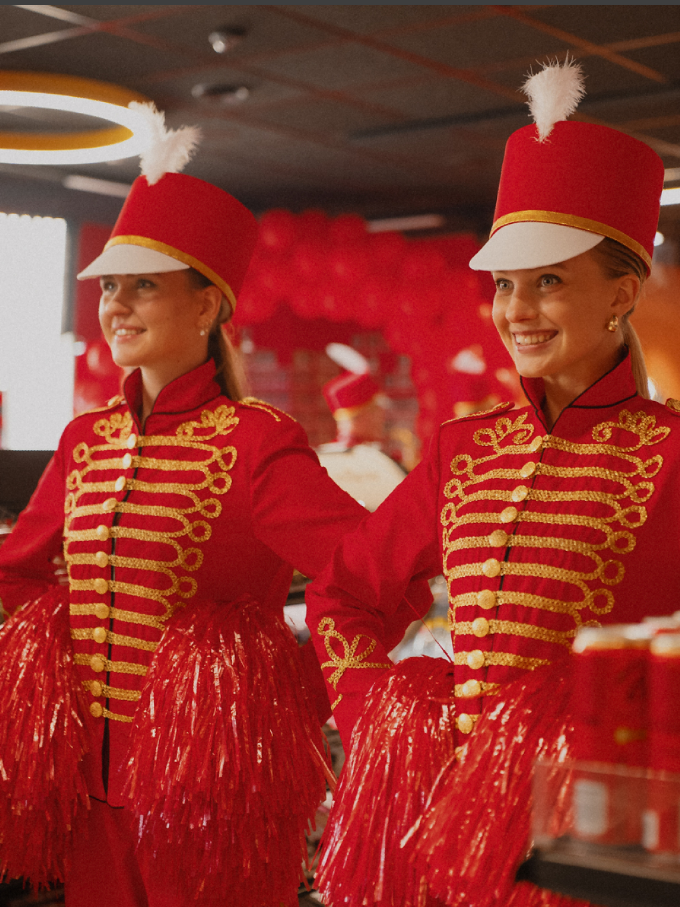 Red marching band costumes designed for bass orchestral performances.